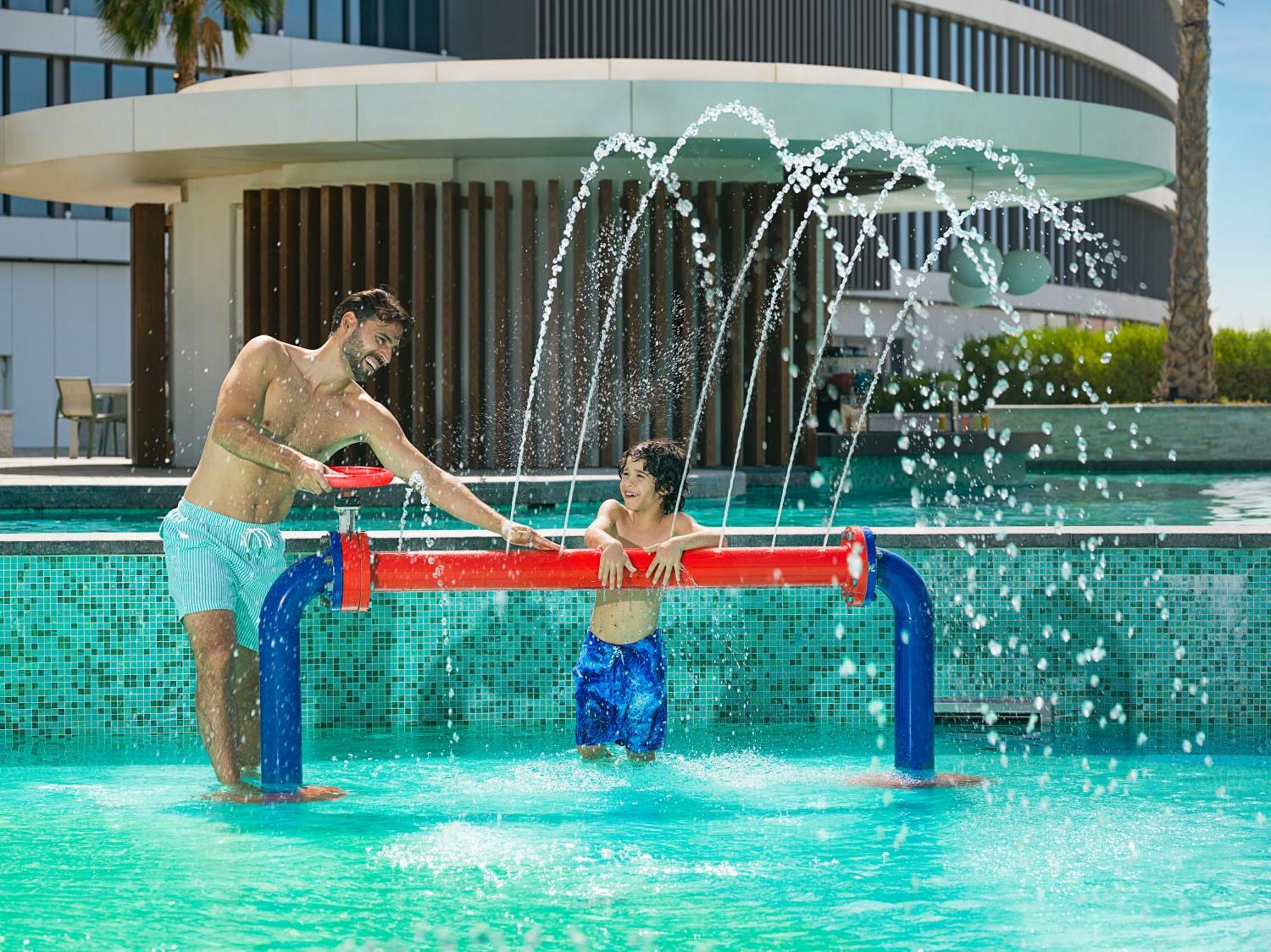 The Wb Abu Dhabi, Curio Collection By Hilton Hotel Exterior photo A father and son playing water hockey